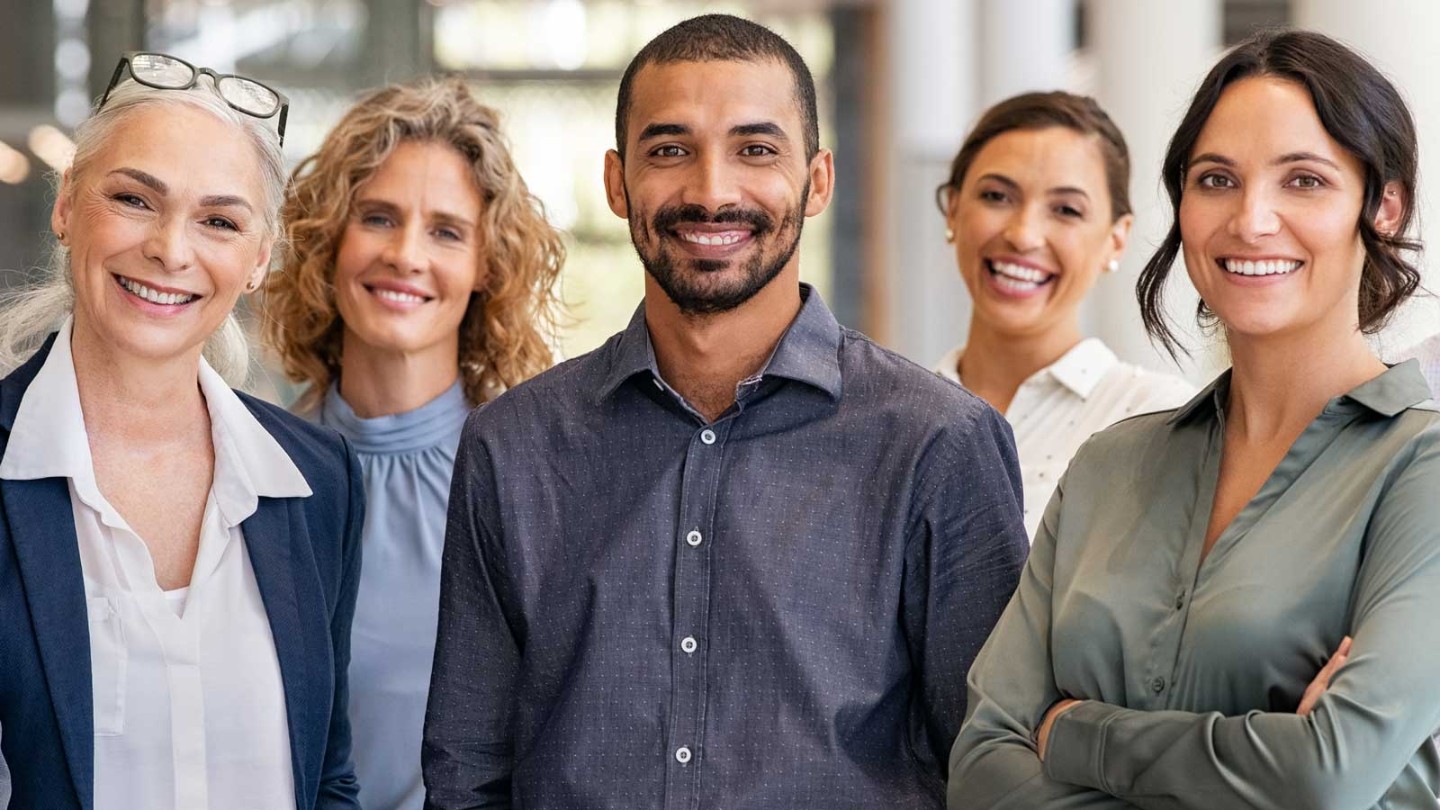 Diverse group of professionally dressed people standing together