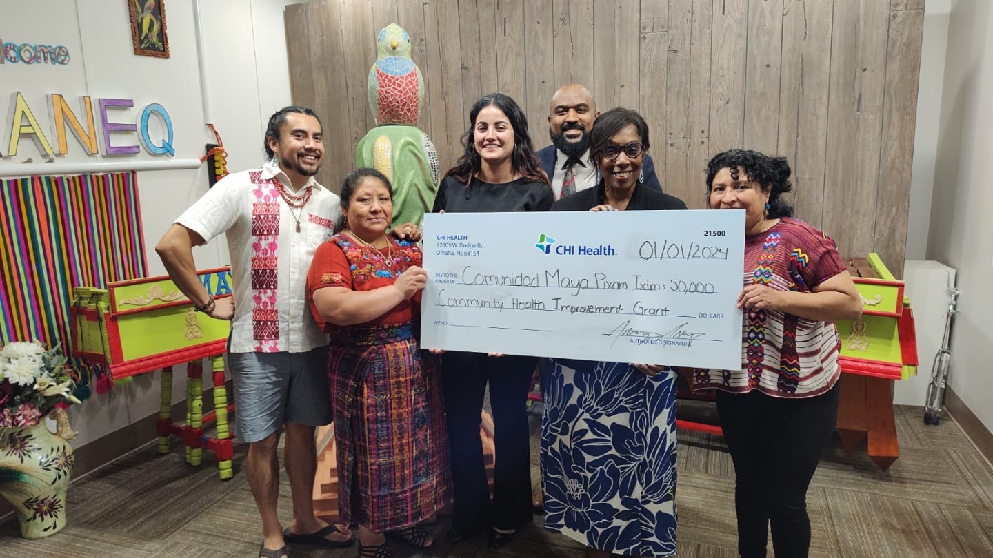 CHI Health Gives $450K in Community Improvement Grants Group photo of check presentation to Comunidad Maya Pixan Ixam