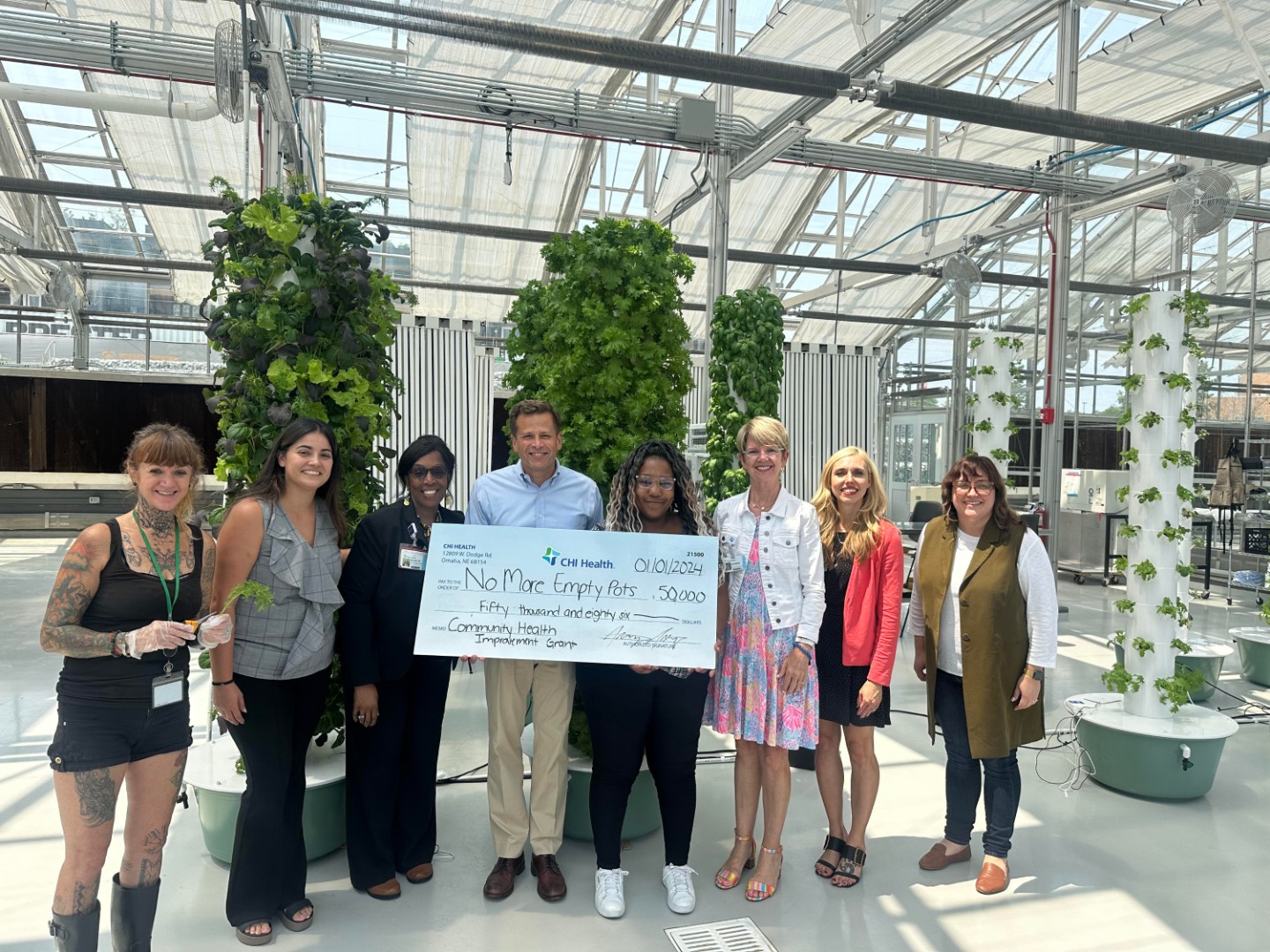 CHI Health Gives $450K in Community Improvement Grants Group photo of check presentation to No More Empty Pots