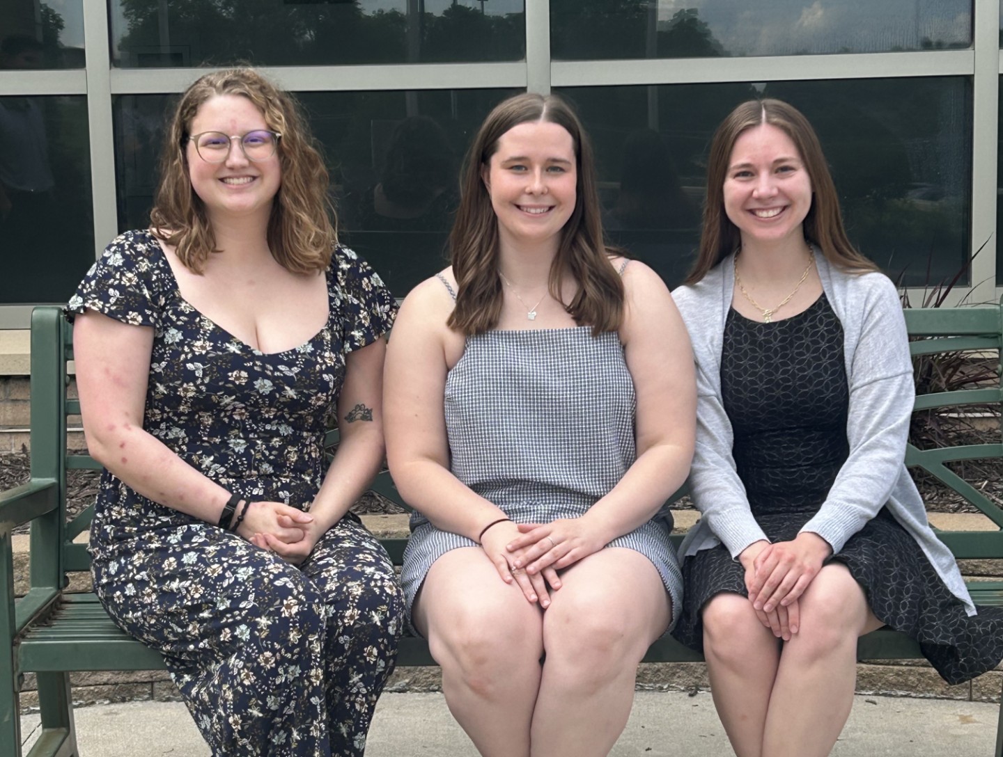 Group photo of four people on a bench