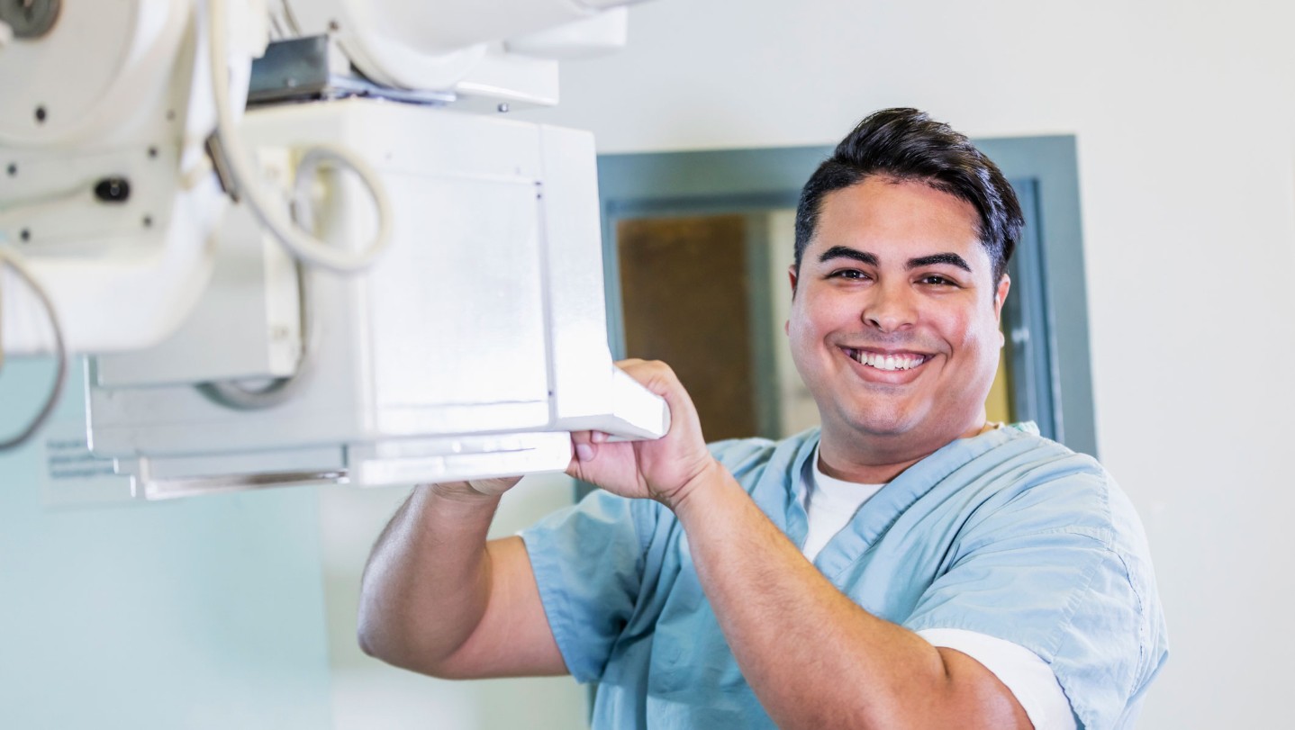 Radiologic technologist holding machine