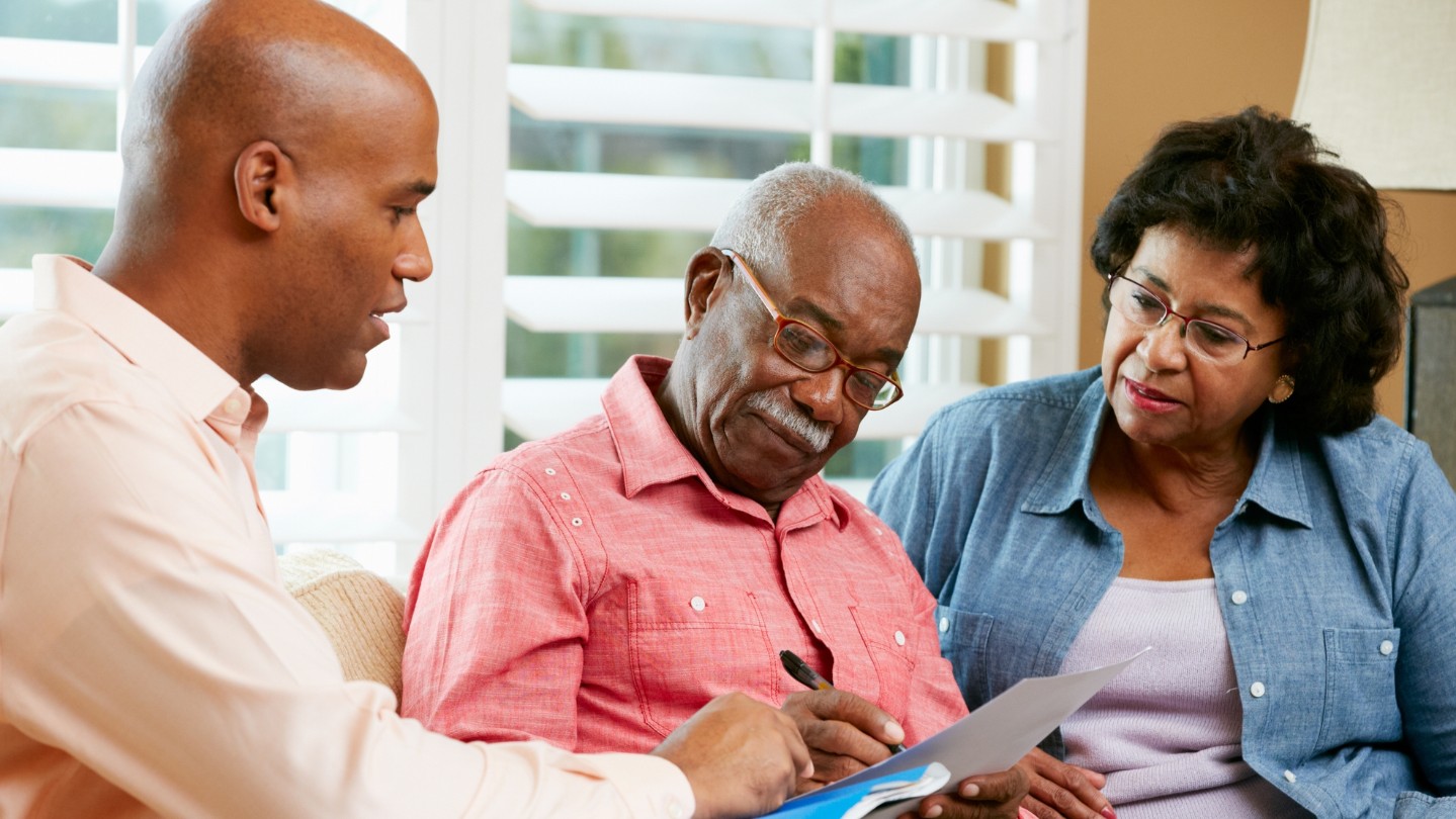 Older African American couple looking at paperwork