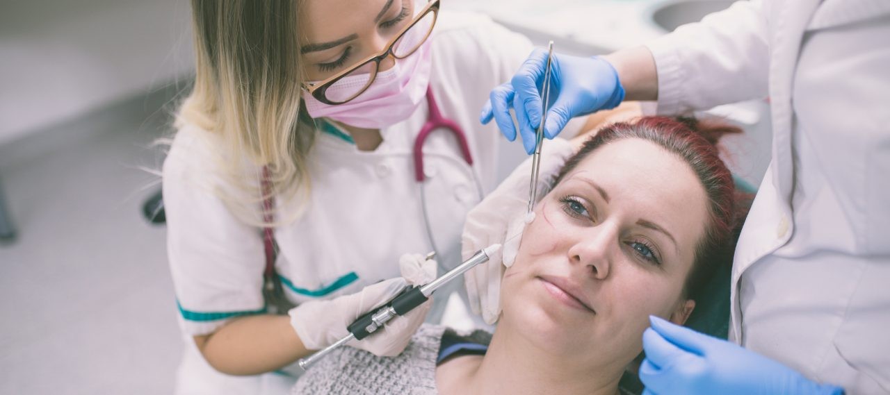 woman having her face analyzed for surgery