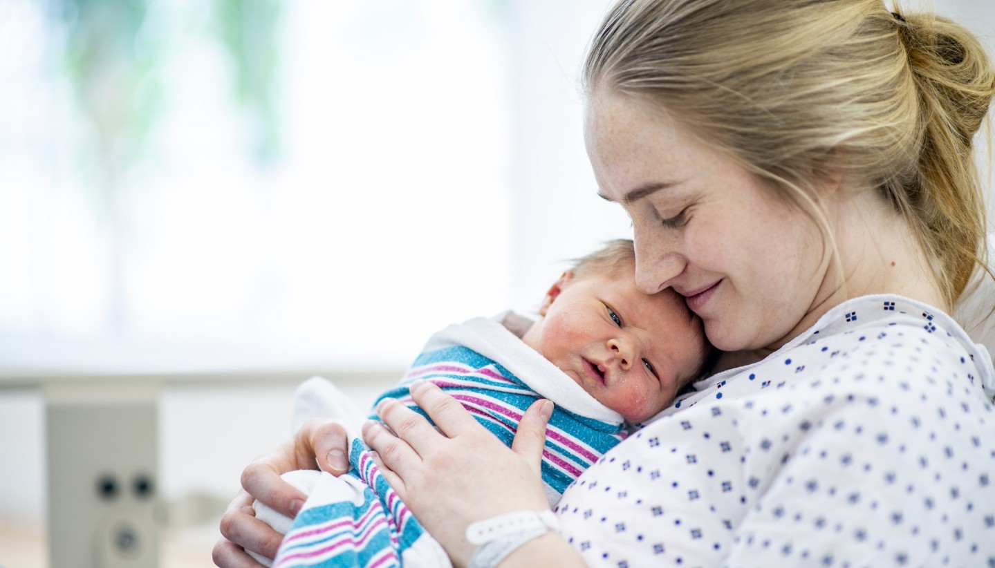 Mother and newborn baby in hospital bed