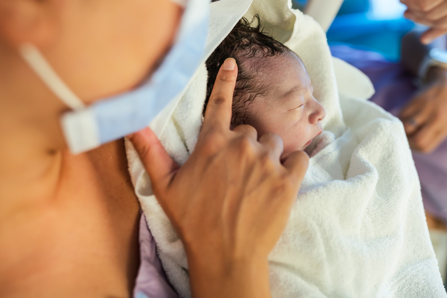 Newborn baby being held by mother