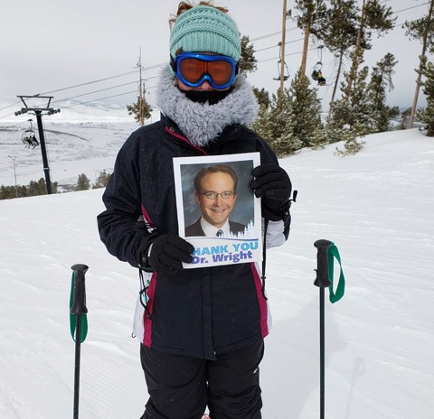 Orthopedic Patient Testimonials Aubrey Zechmann skiing with a photo of Dr. Wright