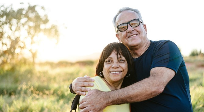 Middle-aged couple hugging and smiling