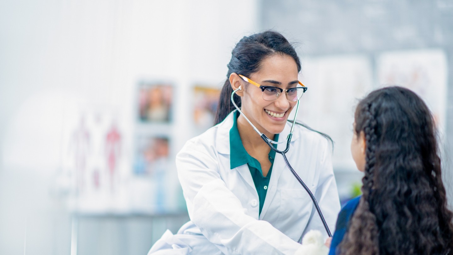 Young female doctor checking on a young patient