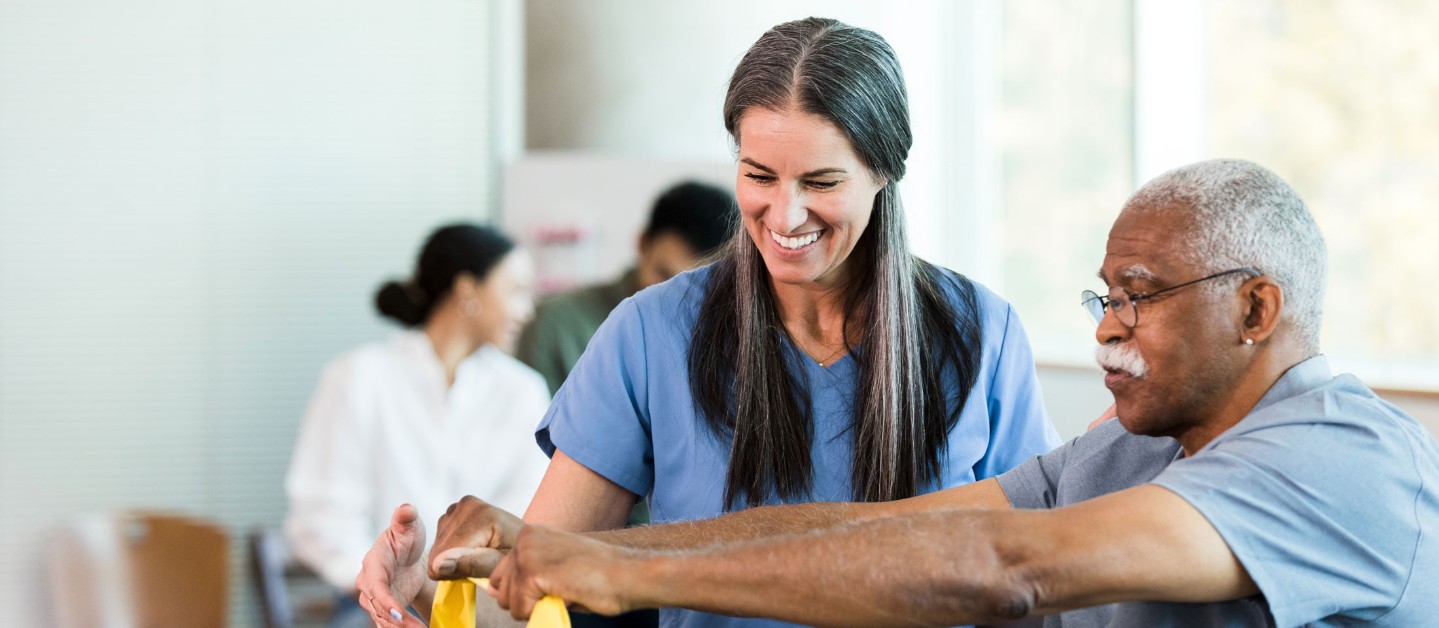 Man using resistance band at therapy appointment