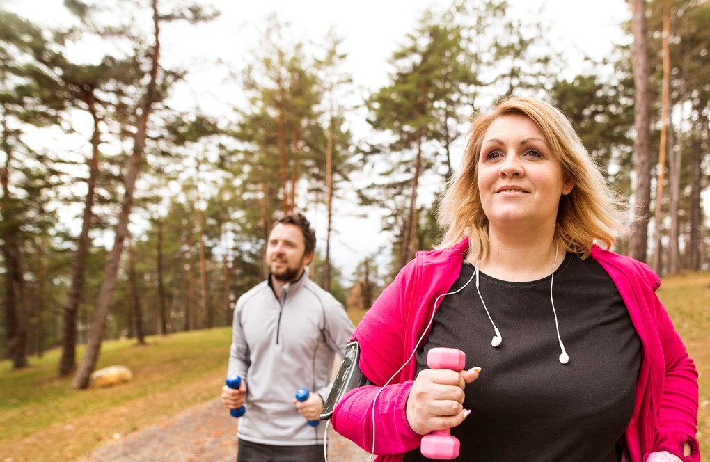 overweight woman exercising outside